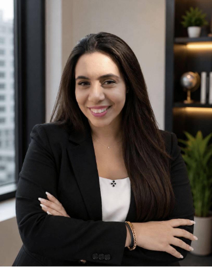 Professional portrait of Rola Fakih, Art Director at MEmob, seated in a modern office with a confident smile.